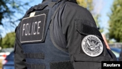 FILE - A member of an Immigration and Customs Enforcement team is pictured during an operation in San Jose, Calif., Sept. 25, 2019.