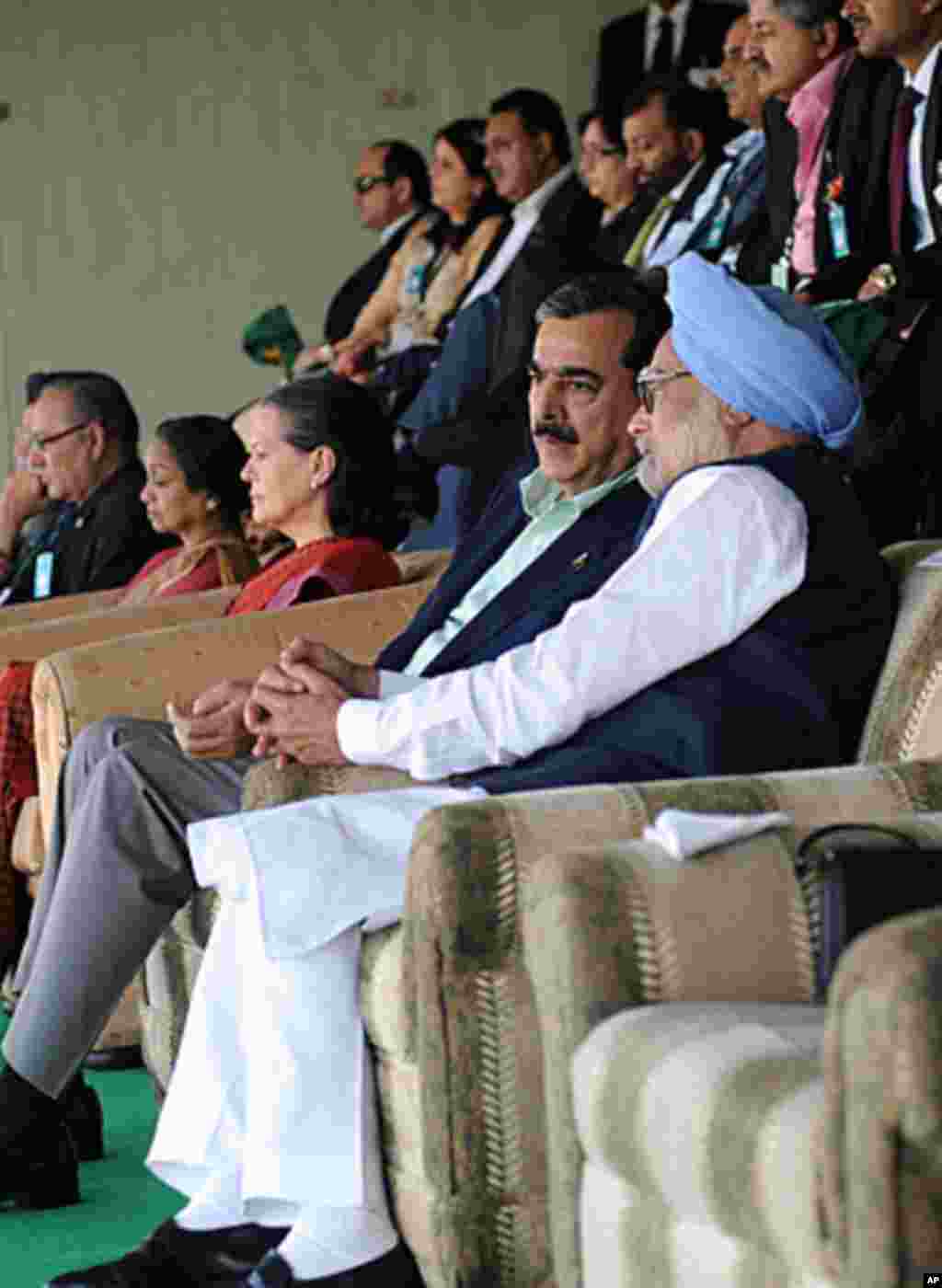 India's Prime Minister Manmohan Singh (R) speaks with his Pakistani counterpart Yusuf Raza Gilani as they watch the ICC Cricket World Cup semi-final match between India and Pakistan in Mohali, March 30, 2011.