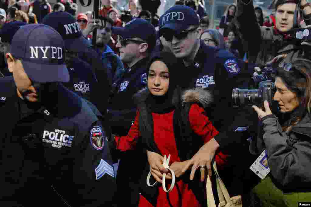 New York Police Department officers arrest a woman who is taking part in a &#39;Day Without a Woman&#39; march on International Women&#39;s Day in New York, March 8, 2017.