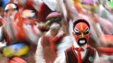 Students wearing traditional opera masks attend an exercise session in Wuhan, Hubei province, China.