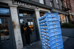 FILE - A bread delivery is made to a Shake Shack restaurant in the Brooklyn borough of New York, March 16, 2020.
