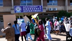FILE - Health workers led by nurses take part in a demonstration over salaries, at Parerenyatwa Hospital in Harare, June, 21, 2022.