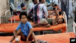 Indian children who fell ill after eating the daily free lunch at a rural Indian school undergo treatment at a hospital in Patna, India, July 18, 2013.