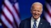 FILE - President-elect Joe Biden smiles as he speaks at The Queen theater in Wilmington, Delaware, Nov. 10, 2020. 