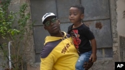 Juan Yainier Antomarchi Nunez holds his son Angelo in Havana, Cuba, Jan. 16, 2025, after being conditionally released from detention for participating in 2021 anti-government protests.