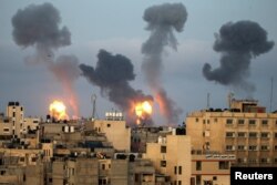 Flames and smoke rise during Israeli air strikes amid a flare-up of Israel-Palestinian violence, in the southern Gaza Strip, May 11, 2021.