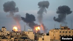 Flames and smoke rise during Israeli air strikes amid a flare-up of Israel-Palestinian violence, in the southern Gaza Strip, May 11, 2021. 