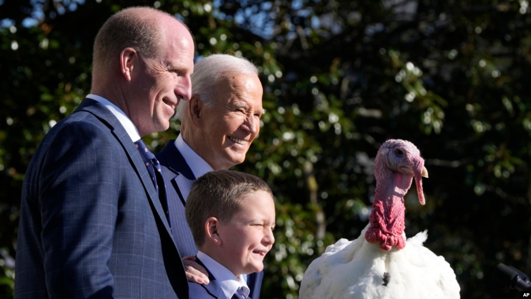 President Joe Biden is pictured with John Zimmerman, chair of the National Turkey Federation, and Zimmerman's son Grant, after pardoning Peach the Thanksgiving turkey during a White House ceremony in Washington, Nov. 25, 2024.