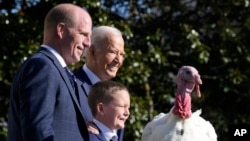 President Joe Biden is pictured with John Zimmerman, chair of the National Turkey Federation, and Zimmerman's son Grant, after pardoning Peach the Thanksgiving turkey during a White House ceremony in Washington, Nov. 25, 2024.