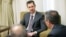 Syria's President Bashar al-Assad (C) is seen during an interview with the al-Thawra newspaper in Damascus in this handout photograph distributed by Syria's national news agency SANA, July 3, 2013