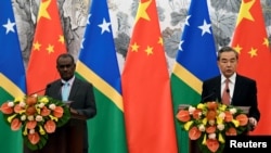 Solomon Islands Foreign Minister Jeremiah Manele and Chinese State Councilor and Foreign Minister Wang Yi hold joint news conference at the Diaoyutai State Guesthouse in Beijing, China, Sept. 21, 2019. 