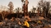 Pedram Salimpour and Stacy Weiss look through the remains of their home, which was destroyed by the Palisades Fire, in the Pacific Palisades neighborhood in Los Angeles, California, Jan. 11, 2025. 