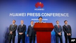 Huawei Rotating Chairman Guo Ping, center, speaks in front of other executives during a press conference in Shenzhen, China's Guangdong province, Thursday, March 7, 2019. 