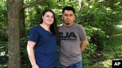 Alyse Sanchez and her husband, Elmer Sanchez, pose for The Associated Press in Sandy Spring, Md, June 21, 2019. 