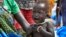 FILE - In this photo taken Dec. 10, 2017, a malnourished baby cries at the feeding center for children in Jiech, Ayod County, South Sudan. 
