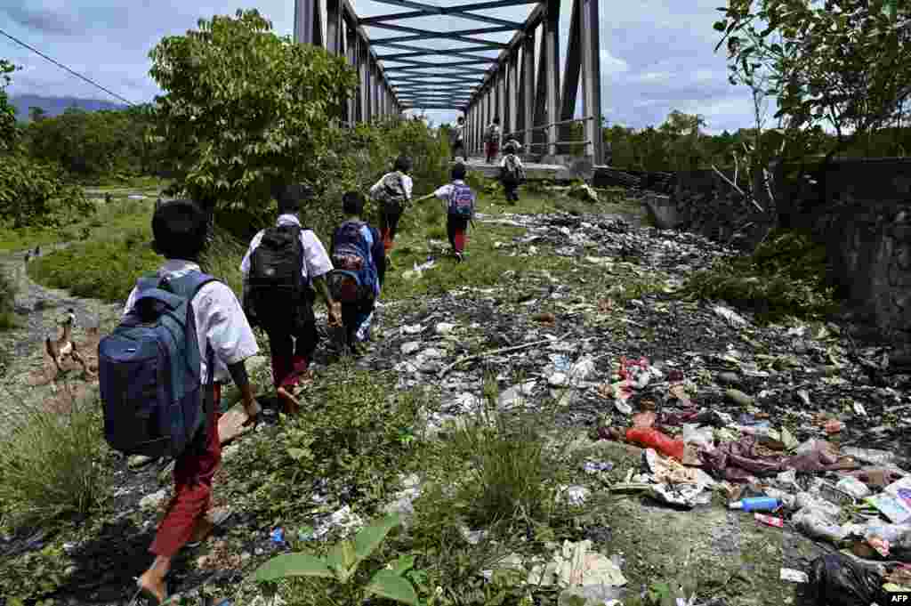 Children are seen on their way home after school in a remote village in Panca, Aceh province, Indonesia.