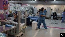 FILE - Medical personnel work in a department transferred to underground parking at Rambam Hospital in the northern Israeli city of Haifa, January 11, 2024