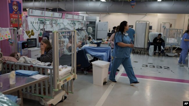 FILE - Medical personnel work in a department transferred to underground parking at Rambam Hospital in the northern Israeli city of Haifa, January 11, 2024