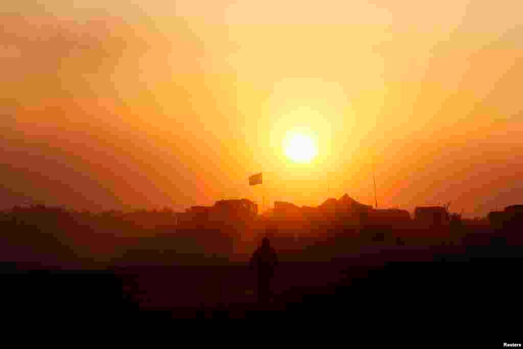 An Israeli soldier walks near the border with the Gaza Strip, Aug. 1, 2014.