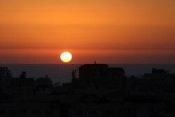 The sun sets over the Mediterranean Sea off the coast of Gaza City as cross-border violence between the Israeli military and Palestinian militants continues, May 14, 2021.