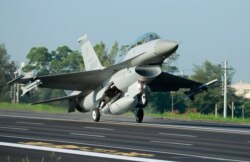 FILE - A Taiwan Air Force F-16 fighter jet lands on a closed section of highway during the annual Han Kuang military exercises in Chiayi, central Taiwan, Sept. 16, 2014. U.S. arms sales to Taiwan now reportedly total some $12 billion.