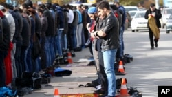 FILE - Men attend a Friday prayer at the mosque on Kotrova street in Dagestan's regional capital Makhachkala, Russia, Nov. 13, 2015.