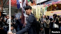 FILE - Activist Baggio Leung attends in an annual New Year's Day march in Hong Kong, China, Jan. 1, 2019. 