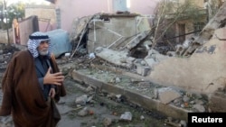 A man surveys the site of a car bomb attack north of Baghdad, Jan. 20, 2014.