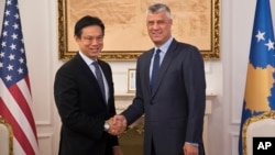 Kosovo's president Hashim Thaci, right, shakes hands with Hoyt Brian Yee, Deputy Assistant Secretary for European and Eurasian Affairs, responsible for U.S. relations with the countries of Central Europe and South Central Europe, Oct. 25, 2017, in Kosovo capital Pristina.