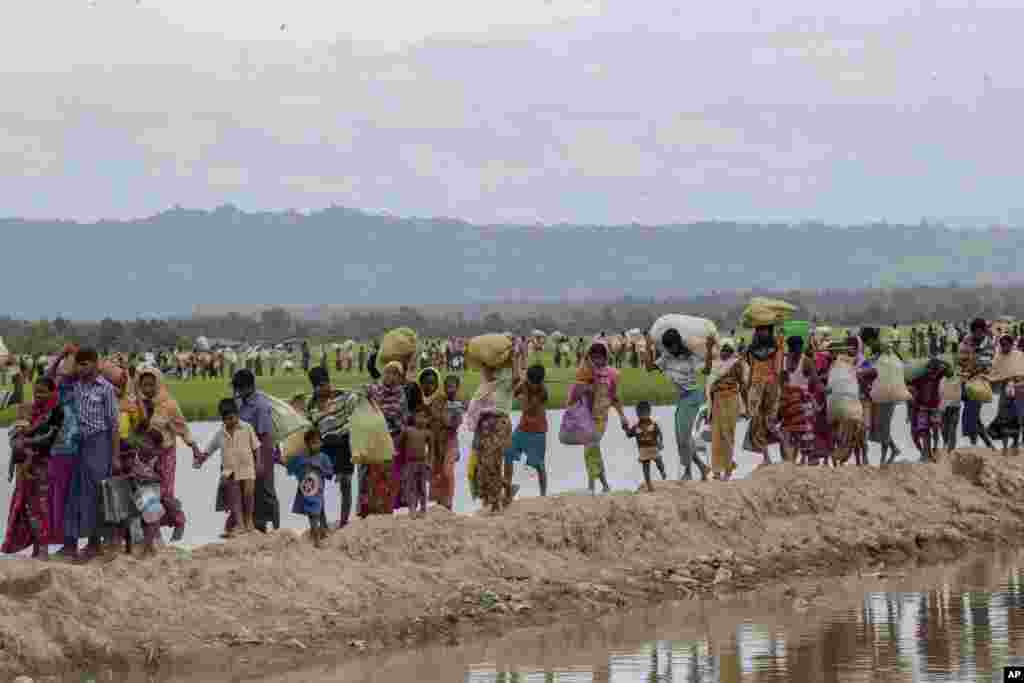 Bangladeş&#39;e girdikten sonra dört gün boyunca tarlada yatan mülteciler eşyalarını toplayarak kendilerine gösterilen mülteci kampına doğru ilerliyor.&nbsp;