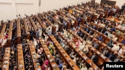 Ethiopia's parliament members raise their hands to vote in favour of the newly appointed President Taye Atske-Selassie Amde at the Parliament Building in Addis Ababa, Oct. 7, 2024.