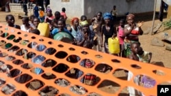 People celebrate as they are released from Ebola quarantine in the village of Massessehbeh on the outskirts of Freetown, Sierra Leone, Aug. 14, 2015.