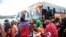 FILE: Burundian refugees get off from a bus which transported them from Tanzania to neighbouring Burundi, as part of a repartition program, at the Nyabitare transit site, in the Gisuru commune, Ruyigi province, Burundi, Oct. 3, 2019.