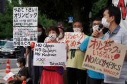 Protesters demonstrate in front of the Prime Minister's Office in Tokyo, Aug. 2, 2021. They were protesting against the Olympics and Paralympics held during the pandemic.