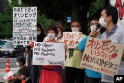 Protesters demonstrate in front of the Prime Minister's Office in Tokyo, Aug. 2, 2021. They were protesting against the Olympics and Paralympics held during the pandemic.