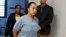 FILE - Cyntoia Brown enters her clemency hearing at Tennessee Prison for Women in Nashville, Tennessee, May 23, 2018.