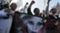 Muslim men shout slogans during a rally against US pop singer Lady Gaga's concert that is scheduled to be held on June 3, outside the US Embassy in Jakarta, Indonesia, May 25, 2012. 