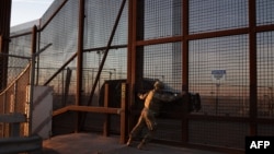 A member of the Texas Military Department opens a fence along the U.S.-Mexico border in El Paso, Texas, Jan. 22, 2025. 