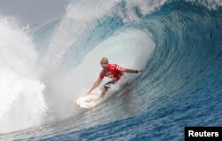 FILE - Australian surfer Mick Fanning rides a wave at Teahupo'o, site of the 2024 Olympics surfing competition in Tahiti, French Polynesia.