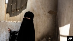 A girl stands in al-Hol camp, which houses families of members of the Islamic State group in Hasakeh province, Syria, April 19, 2023.