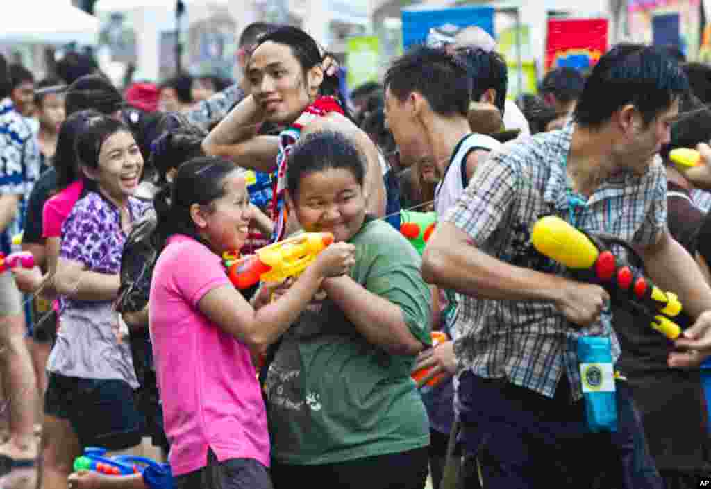 April 13: Thais have a water gun battle in an attempt to set a world record for water splashing during Thai New Year celebrations in Bangkok.  The annual New Year celebrations, which takes over most Thai cities and villages, last for three days.  (AP Phot