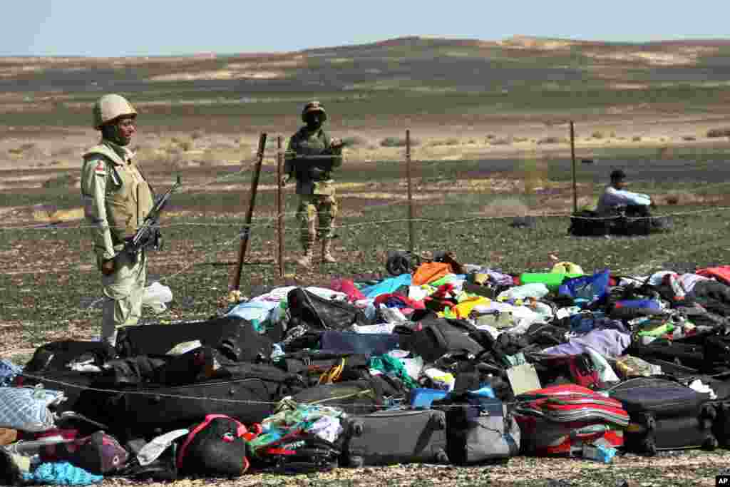 Egyptian Army soldiers stand near luggage and personal belongings of passengers a day after a passenger jet bound for St. Petersburg, Russia, crashed in Hassana, Egypt. The Metrojet plane crashed 23 minutes after it took off from Egypt&#39;s Red Sea resort of Sharm el-Sheikh on Oct. 31, 2015. All 224 people on board died.