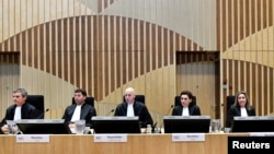 FILE - Judges attend the criminal trial against four suspects in the July 2014 downing of Malaysia Airlines flight MH17, in Badhoevedorp, Netherlands, March 10, 2020. 