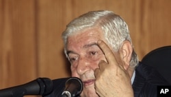 Syrian Foreign Minister Walid al-Moualem speaks during a news conference in Damascus, June 22, 2011