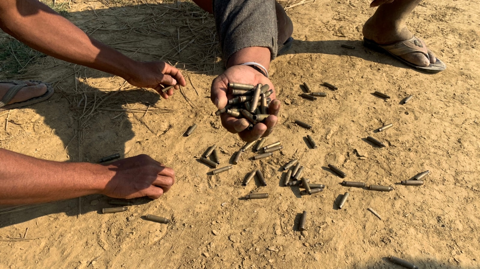 FILE - Residents hold bullet shells in a village in Rathedaung township, Rakhine state, Jan. 28, 2019, where fighting between the Myanmar military and ethnic Arakan Army (AA) took place from January 26 to 28.