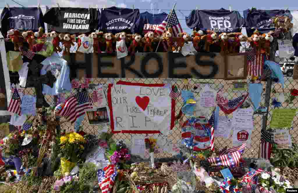 A memorial of mementos dedicated to the 19 firefighters killed in the nearby wildfire is seen in Prescott, Arizona, July 8, 2013. 