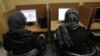 Iranian women use computers at an Internet cafe in central Tehran, Iran on Feb. 13, 2012. Many Iranian users are reporting Gmail and other Google products have been blocked.