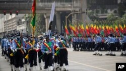 Ethiopian police holding national flags march during a parade to display new uniforms ahead of an election, in Meskel Square in downtown Addis Ababa, June 19, 2021.