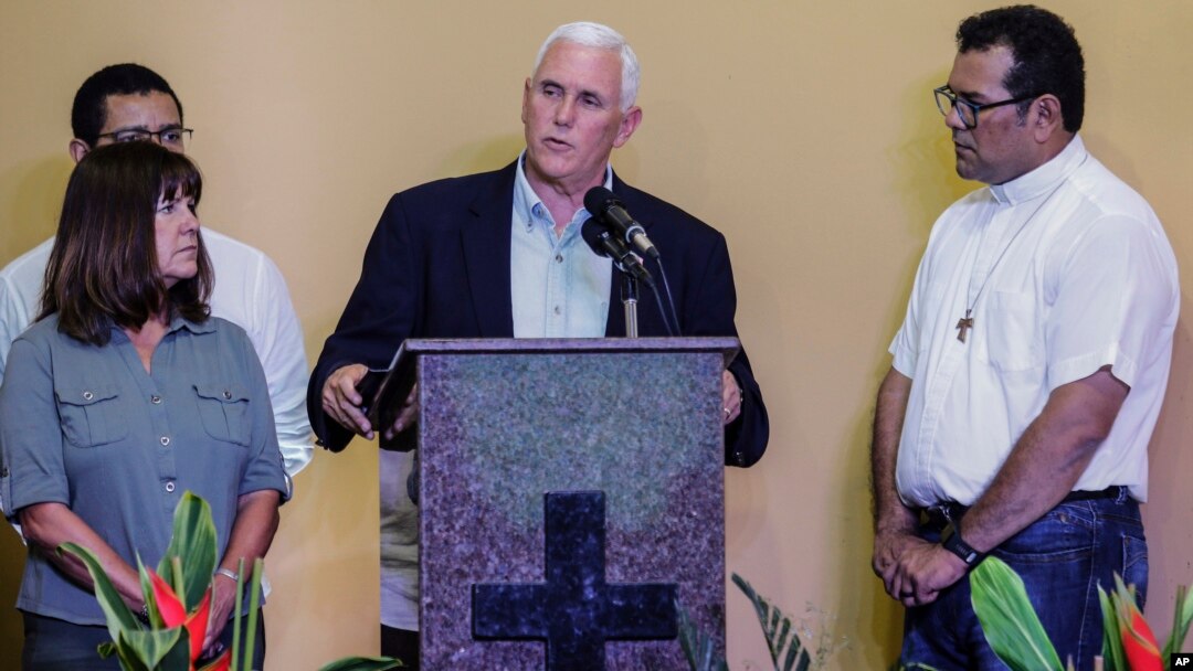 U.S. Vice President Mike Pence, center, accompanied by his wife Karen, left, speaks after a meeting with Venezuelan families at the Santa Catarina migrant shelter, in Manaus, Brazil, June 27, 2018. 