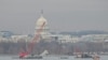 A crane removes airplane wreckage from the Potomac River, where American Airlines flight 5342 collided with a US Army military helicopter, near Ronald Reagan Washington National Airport in Arlington, Virginia, on February 3, 2025.